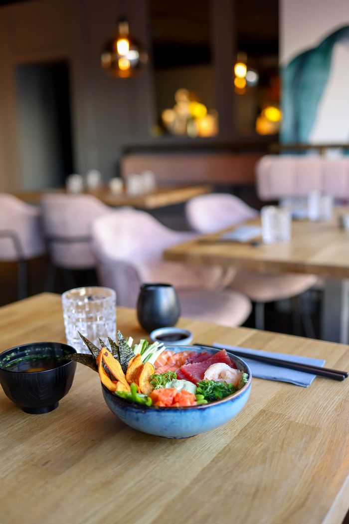 Delicious seafood bowl served indoors at a modern restaurant with elegant decor.
